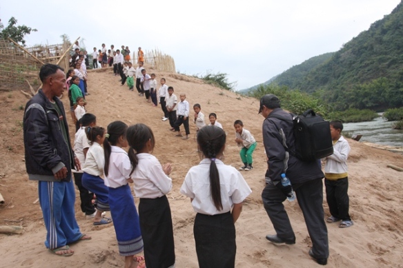 Wow - what a welcoming committee - the kids lined the river bank followed by the villagers lining the path to the school grounds